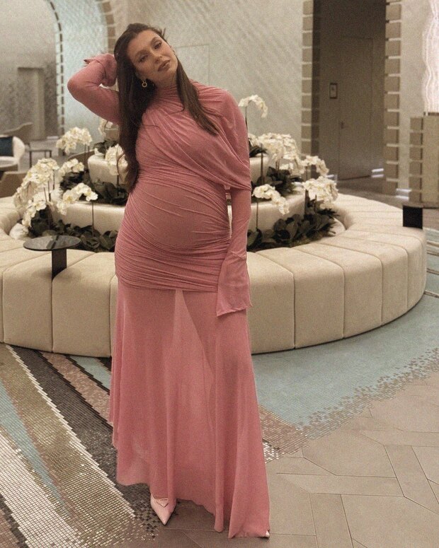 A draped rose gown at an evening event, third trimester